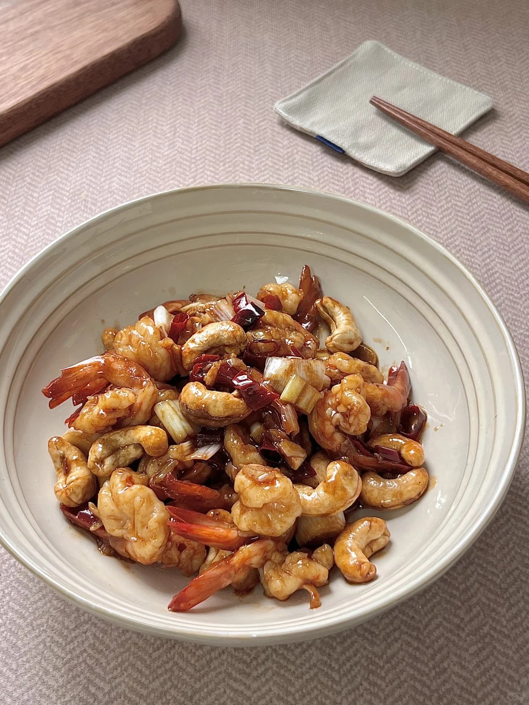 Curled shrimp, cashews and dried red chiles coated in sauce.
