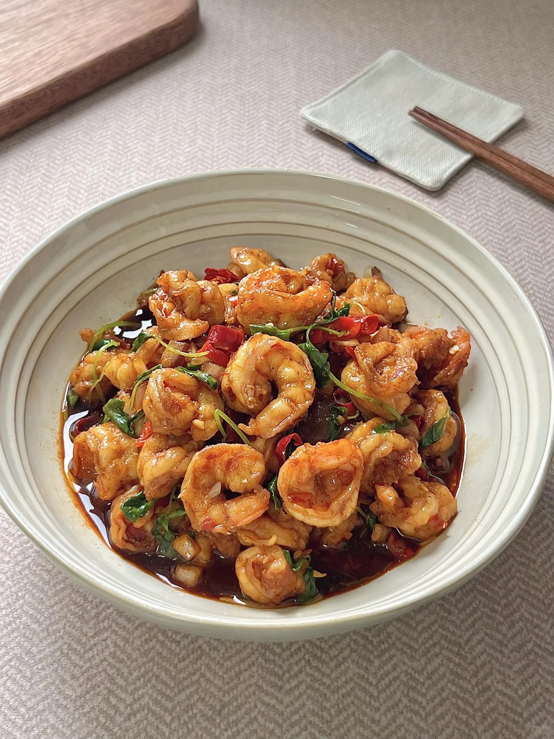 Curled shrimp with red chiles and green herbs.