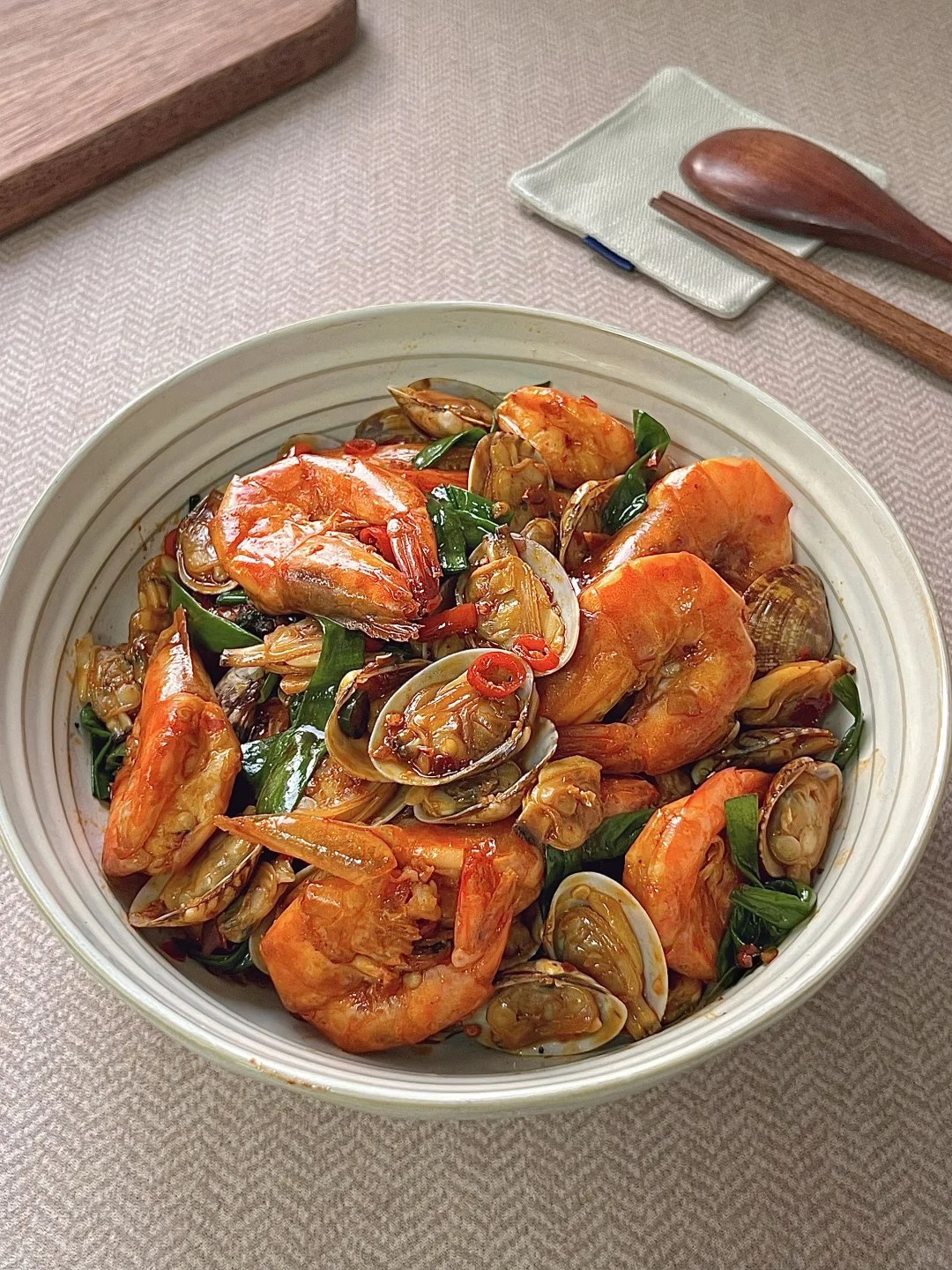 Shrimp and opened clams coated in red chile sauce.