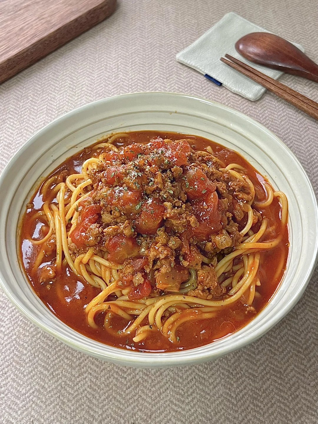 Pasta coated in tomato sauce with ground beef.