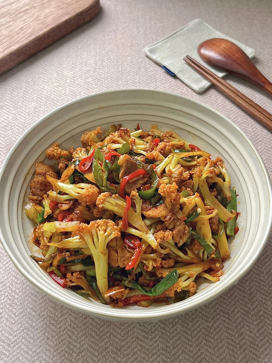 Cauliflower florets with pork belly, dried chiles and green peppers.