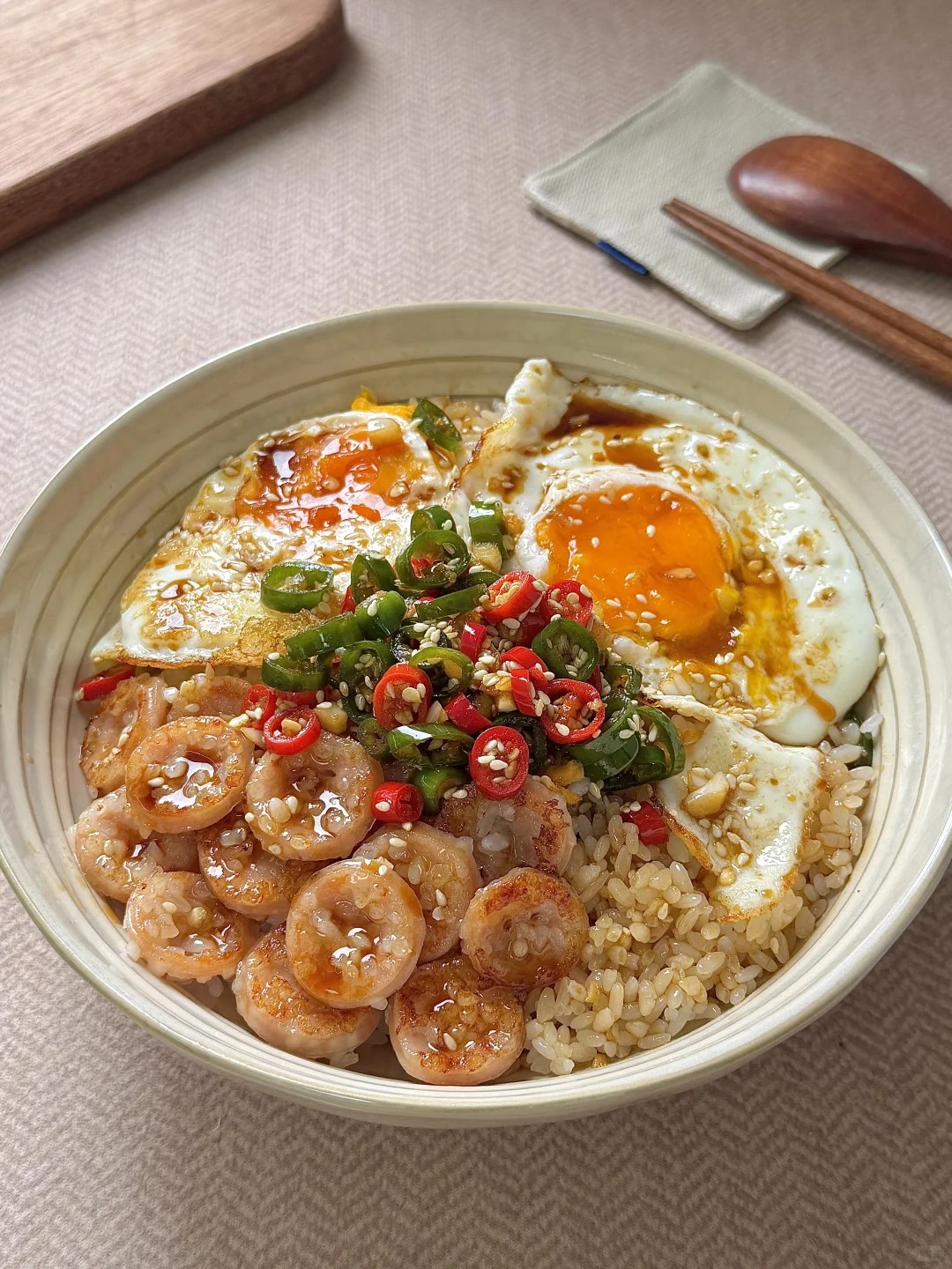 Fried eggs and sausage slices over rice with a chopped chile dressing.